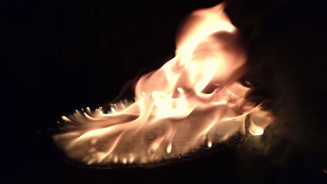 Slow-motion-shot-of-pitchy-stump-burning-and-naturally-fueling-by-its-own-tar-by-dark-night