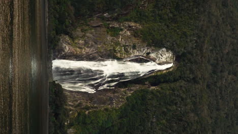 Lady-bowen-falls,-New-Zealand---White-foaming-water-falls-from-the-cliff,-vertical