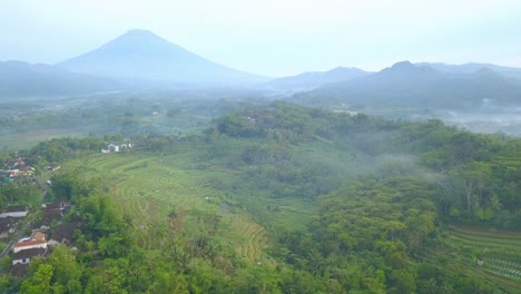 Aerial-panning-shot-of-hilly-tropical-landscape-and-mountains-in-Indonesia