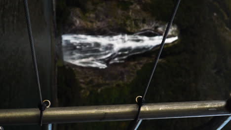 Slomo-portrait-Looking-through-the-hand-railings-on-a-boat-towards-Bowen-falls