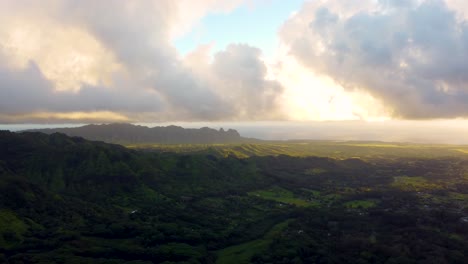 Golden-sunshine-glowing-on-horizon-at-beautiful-sunrise-on-Kauai-Hawaii-island-under-tropical-rain-clouds