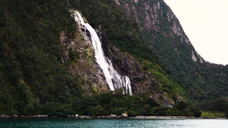 Lady-bowen-falls-waterfall-from-distance-in-milford-sound,-New-Zealand
