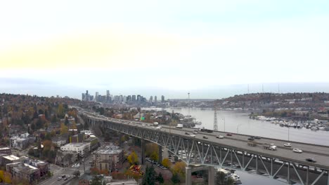 Drone-shot-of-cars-driving-on-I-5-through-Seattle's-bustling-city