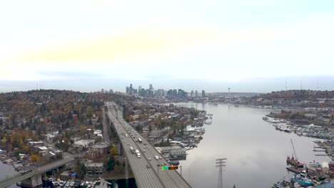 Establishing-aerial-shot-of-an-overcast-Seattle-skyline-with-traffic-passing-underneath