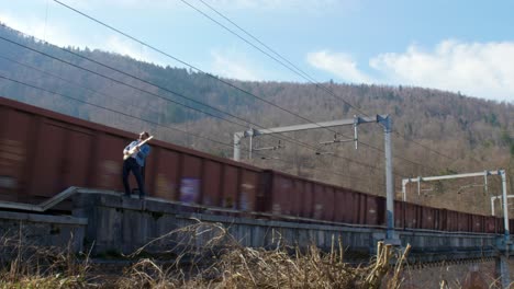 Guitar-Player-on-a-Bridge-in-Front-of-a-Moving-Train