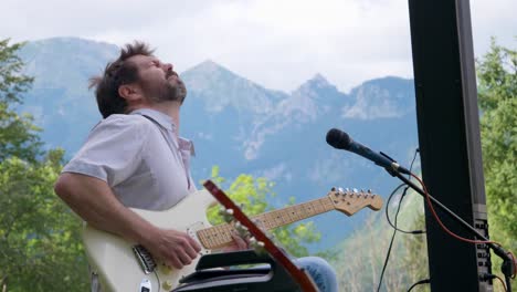 Guitar-Player-Emotional-Feeling-it-Below-Mountains-Alps-Slovenia
