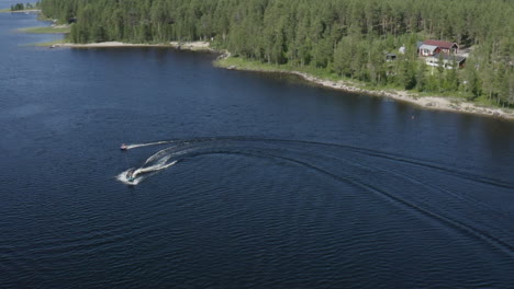 Aerial-view-of-a-ringo-ride-behind-a-jetski-in-a-river-in-Sweden