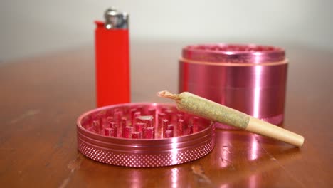 Pan-across-joint-propped-up-on-grinder-top,-lighter-in-the-background