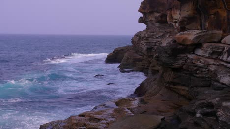 Waves-rushing-towards-the-beautiful-rock-formation-of-the-Bronte-Beach-in-Australia---Slow-motion