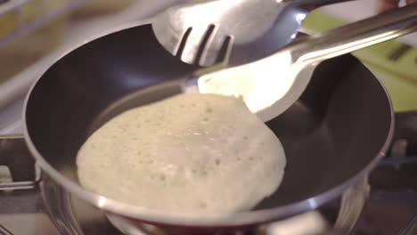A-Beginner-Having-Difficulty-Cooking-Pancake-In-A-Teflon-Pan---Closeup-Shot