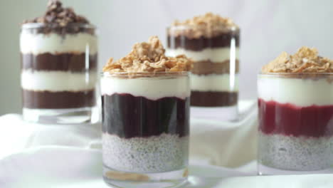 Studio:-zoom-out-of-delicious-layered-blended-chia-pudding,-white-background