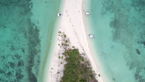 Aerial-top-down-view-of-an-island-with-three-Philippines-local-boat