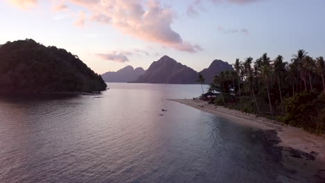 Aerial-view-of-El-Nido-beach-during-Sunset-with-tourist-at-the-beach