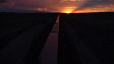 Freight-train-heading-towards-setting-sun-in-Arizona