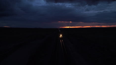 Freight-train-cutting-through-landscape-at-night-in-Arizona