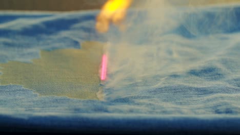 Shot-of-laser-burning-of-jeans-in-jeans-making-factory
