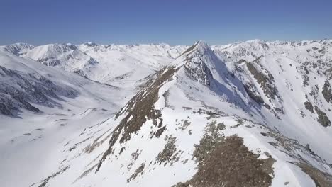 Snow-Covered-Alpine-Mountain-Range,-Aerial-Forward