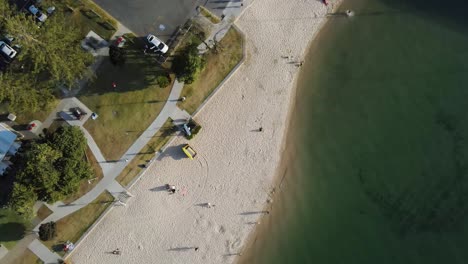 People-Relaxing-On-The-Sandy-Shore-Of-Tallebudgera-Creek---Tourist-Destination-In-Queensland,-Australia---Aerial-drone