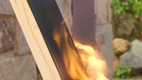 Strong-flames-on-pine-wood-plank,-close-up-macro-shot