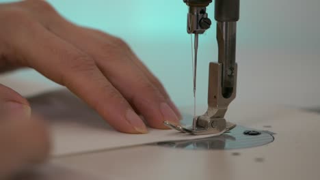Extreme-Closeup-of-Hands-and-Sewing-Machine-Needle-Pumping-Up-and-Down