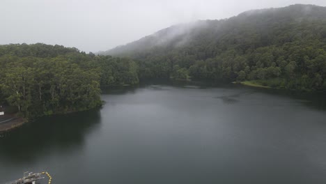 Impound-Water-At-Reservoir---Karangi-Dam-On-A-Foggy-Day-With-Dense-Mountain-Forest-In-NSW,-Australia