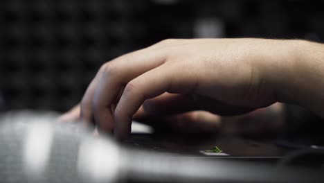 Close-Up-Male-Hands-Typing-On-Laptop-In-Music-Studio