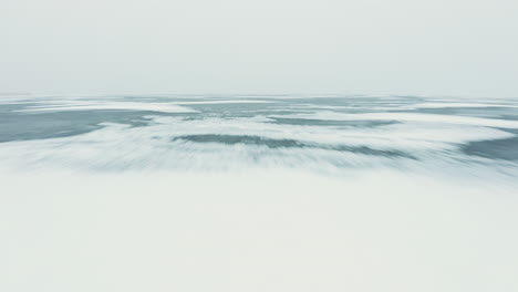 Inception-movie-like-fast-flying-drone-shot-over-foggy-frozen-ice
