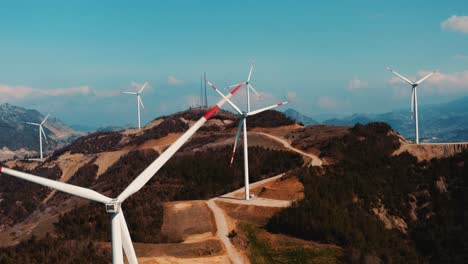 Drone-View-Of-Wind-Turbines-Spinning-On-Top-Of-A-Mountain