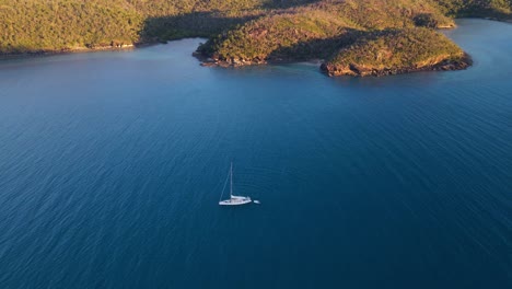 Sailboat-With-Dinghy-Floating-On-Calm-Water-Of-Nara-Inlet---Hook-Island-In-Whitsundays,-Australia