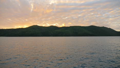 Beautiful-bright-sunset-behind-Hook-Island,-Australia--Wide
