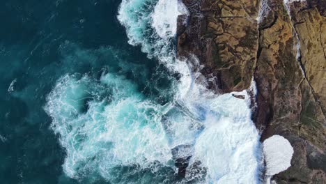Ocean-Foamy-Waves-Crashing-At-The-Big-Rocks-At-The-Beach-In-Australia
