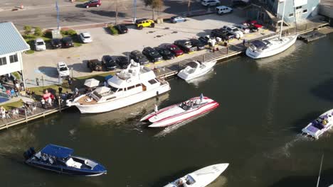 Aerial-View-Of-People-In-Powerboat-Next-To-A-Luxury-Yacht-In-The-Marina
