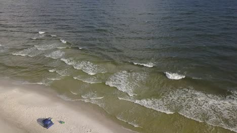 Beautiful-Sea-With-Foamy-Waves-Rolling-And-Crashing-On-A-Sandy-Beach---aerial-drone-shot