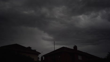 Dark-and-threatening-storm-clouds-cover-the-sky-above-homes,-4K