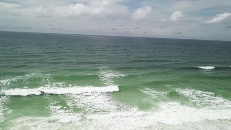 Deep-Blue-Sea-Waters-Splashing-With-Foamy-Waves---aerial-drone-shot