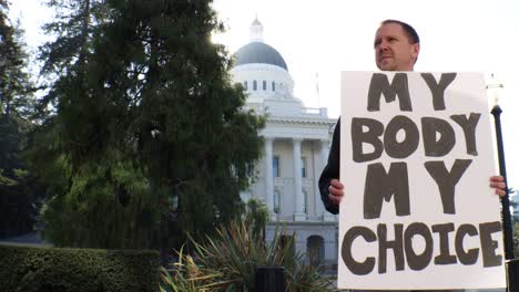 Male-Political-Protester-with-My-Body-My-Choice-Sign-Slider-Dolly-Tracking-Shot