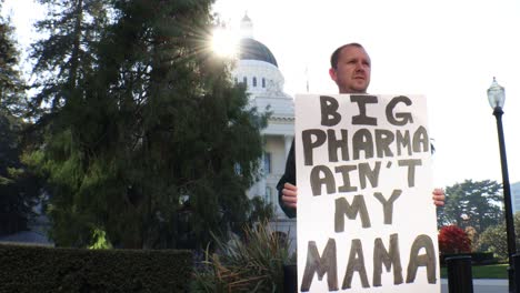 Male-Political-Protester-with-Big-Pharma-Ain't-My-Mama-Sign