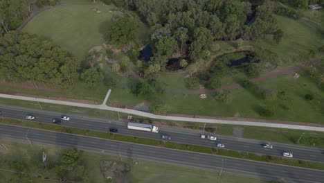 Aerial-View-Of-Traffic-Driving-Along-The-Kershaw-Gardens---Botanical-Garden-In-Park-Avenue,-QLD,-Australia