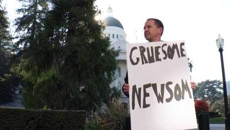 Male-Political-Protester-with-Gruesome-Newsom-Sign-Slider-Dolly-Tracking-Shot