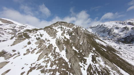 Snow-capped-mountain-massif-of-Pyrenees,-Andorra.-Aerial-forward
