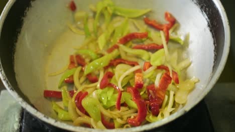 Cook-fries-green-and-red-pepper-in-a-pan