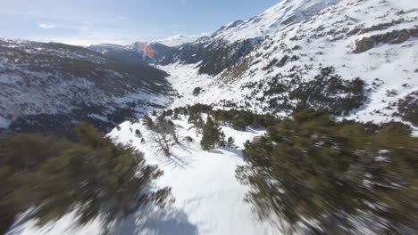 Crazy-racing-drone-flying-over-snowy-landscape-of-Pyrenees-mountains