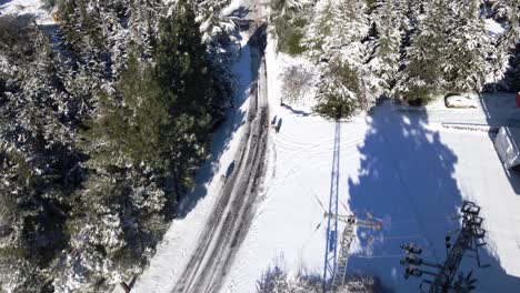 Bird's-eye-view-over-snow-covered-road-and-a-small-village-community-in-the-Golan-Heights-in-Israel