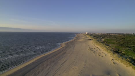Aerial-view-along-Kijkduin-Beach-during-sunset