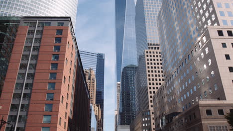Downtown-Manhattan-streets-and-One-World-Trade-Center,-tilt-up