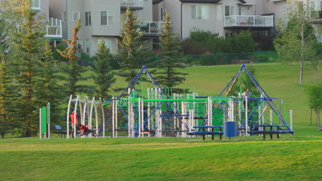Playground-located-in-a-neighbourhood-during-summer-in-Alberta,-Canada-in-a-grass-field