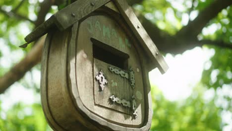 Old-vintage-bird-feeder-house-on-a-green-tree