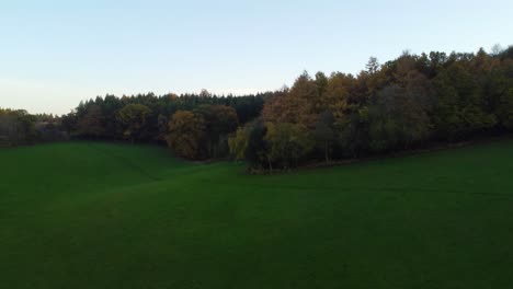 Autumn-Aerial-Shot-Rising-Over-Forest-and-English-Countryside-in-Golden-Hour-Sunset-Light-4K---Drone-Shot