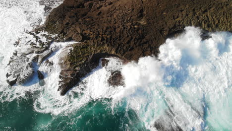 Top-View-Of-Powerful-Foamy-Waves-Hit-On-Rocky-Shore