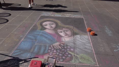 Religious-street-art-found-in-Assisi-drew-with-coloured-chalks-on-a-square
